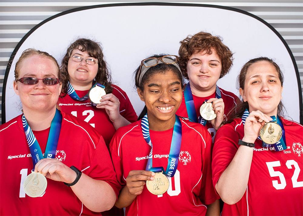 Special Olympics participants showing off medals